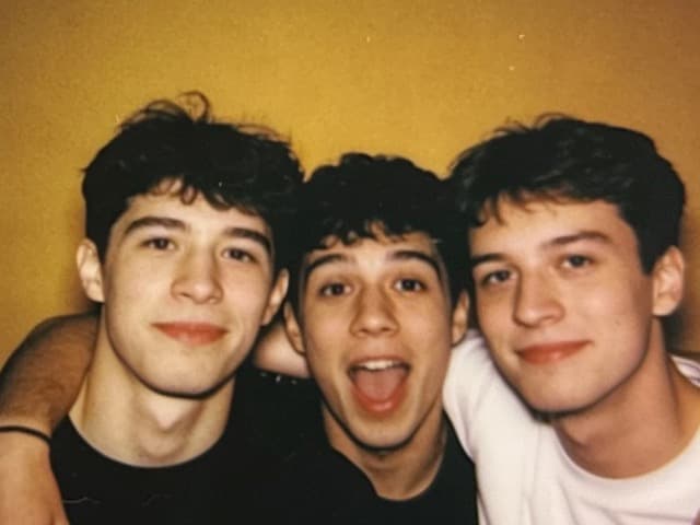 The same three friends mid-laugh, heads close together